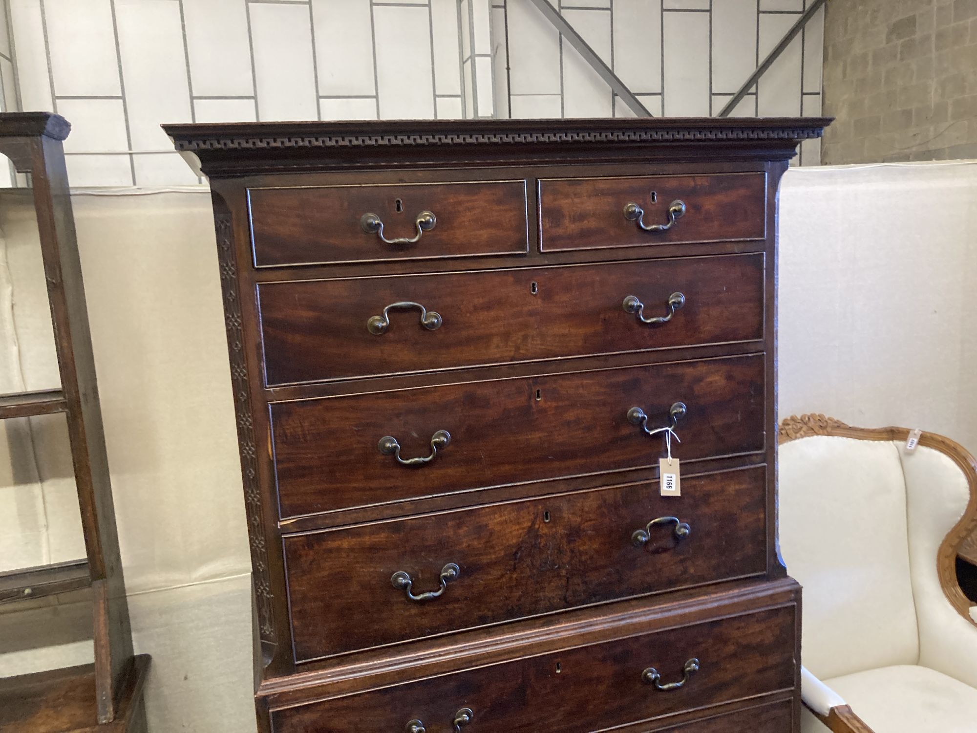 A George III mahogany chest on chest, two short and three long graduated drawers, the base with three graduated cockbeaded drawers, on